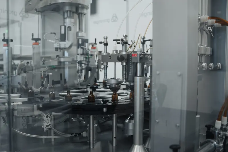 Amber dropper bottles on the Adept liquid filling carousel